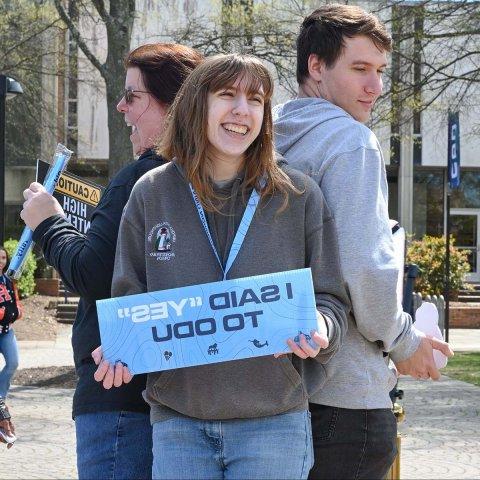 student holding I said Yes to ODU sign